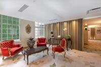 a living room with red chairs and a table at Gran Hotel Costa Rica, Curio Collection By Hilton in San José