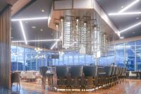 a restaurant with a long bar with chairs and chandeliers at Gran Hotel Costa Rica, Curio Collection By Hilton in San José
