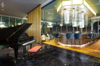 a grand piano in a restaurant with a bar at Gran Hotel Costa Rica, Curio Collection By Hilton in San José
