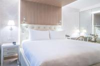 a bedroom with a large white bed and a desk at Gran Hotel Costa Rica, Curio Collection By Hilton in San José