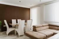 a dining room with a couch and a table and chairs at Apartman Stil in Bugojno