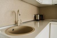 a kitchen sink with a faucet on a counter at Apartman Stil in Bugojno