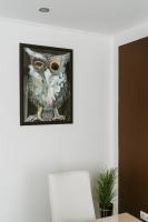 a painting of an owl hanging on a wall at Apartman Stil in Bugojno