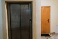 a black door next to a wooden door sidx sidx sidx at Apartman Stil in Bugojno