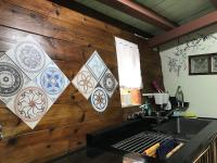 a kitchen with a wooden wall with tiles on it at A-HOME in Jiufen