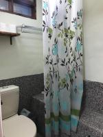 a bathroom with a toilet and a shower curtain at A-HOME in Jiufen