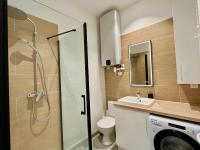a bathroom with a shower and a toilet and a sink at Suite Clovis 2 in Reims