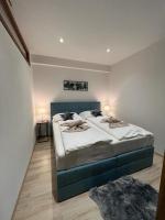 A bed or beds in a room at LUX apartmany Romantika CHOPOK 7, 19