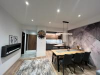 A television and/or entertainment centre at LUX apartmany Romantika CHOPOK 7, 19