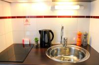 a kitchen counter with a sink and a coffee maker at Appart&#39;City Confort Pau Centre in Pau
