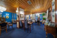 a dining room with blue walls and wooden ceilings at Hotel Bosnali in Adana