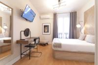 Postel nebo postele na pokoji v ubytování SUITES YOU Gran Vía