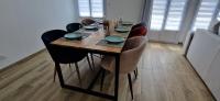 a dining room table with chairs and a wooden tableablish at Maison 4 A 6 Personnes in Belleville-sur-Mer