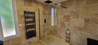 a bathroom with a shower with a glass door at Maison 4 A 6 Personnes in Belleville-sur-Mer