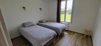 two beds in a room with a window at Maison 4 A 6 Personnes in Belleville-sur-Mer