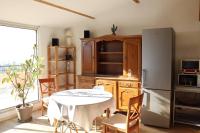 a kitchen with a table and a refrigerator at Estaque Cozy nest with a magical view of the sea in Marseille