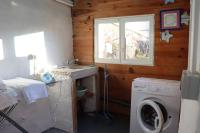 a laundry room with a sink and a washing machine at Estaque Cozy nest with a magical view of the sea in Marseille