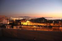 a view of a city at night at Estaque Cozy nest with a magical view of the sea in Marseille