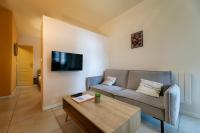 a living room with a couch and a coffee table at Perpignan - Appartement en centre ville in Perpignan