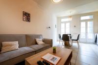 a living room with a couch and a table at Perpignan - Appartement en centre ville in Perpignan