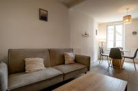 a living room with a couch and a table at Perpignan - Appartement en centre ville in Perpignan