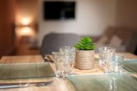 a wooden table with glasses and a small plant on it at Perpignan - Appartement en centre ville in Perpignan