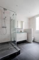 a white bathroom with a shower and a sink at Veeve - Peaches of Paris in Paris