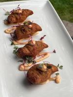 a white plate with four food items on it at Delta Hotels by Marriott Basking Ridge in Basking Ridge