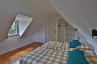 a bedroom with two beds in a attic at Gîte Louannec - Ty Bleiz in Louannec