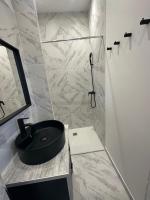 a bathroom with a black sink and a shower at La maison de Giulia Menton in Menton