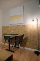 a table and a chair in a room with a wall at Le Jockey - SIPCO Immobilier - Centre in Saint Lo