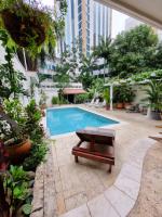 a swimming pool with a bench next to a building at Bodhi Panama City in Panama City