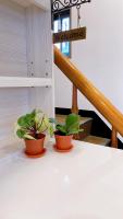 two plants sitting on a table next to a staircase at Sun B&amp;B in Taitung City