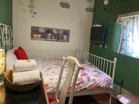 a childs bedroom with a crib and a chair at Shenten Homestay in Jincheng