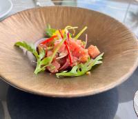 een bruine kom met salade op een tafel bij Amora Beach Resort Phuket in Bang Tao Beach