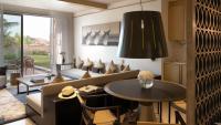 a living room with a couch and a table at Jumeirah Muscat Bay Oman in Muscat