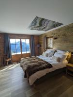 Posteľ alebo postele v izbe v ubytovaní La Boutame : chalet au pied des pistes à Villard Reculas