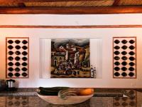 a painting hanging on a wall with a bowl of fruit at Maria Bonita Hotel in Villa de Leyva