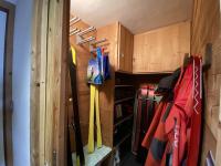 a small room with a closet with skis and bags at Alpe d&#39;Huez Houses - Chalet des Roches - Duplex, SUR les pistes de 3 chambres ! in LʼHuez