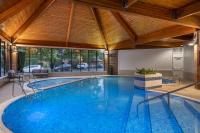 a large swimming pool in a house with a wooden ceiling at Delta Hotels by Marriott York in York
