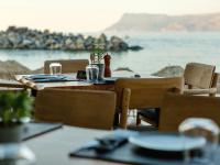 a table and chairs with a view of the ocean at Aphrodite Beach in Kissamos