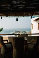 a view of the ocean from the porch of a house at Hotel Boutique casa la Malagueña in San Agustinillo