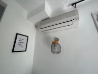 a room with a air conditioner on a ceiling at Cozy home&amp;garden (Paris&#47;Disney) in Noisy-le-Sec