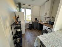 a small kitchen with a refrigerator and a table at Cozy home&amp;garden (Paris&#47;Disney) in Noisy-le-Sec
