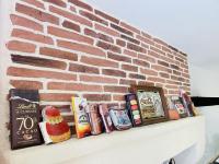 a brick wall with books on a shelf next to at Gite du Moulin in Saint-Laurent-dʼAndenay