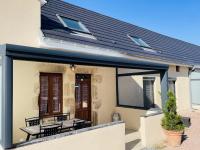 a patio extension with two benches on a house at Gite du Moulin in Saint-Laurent-dʼAndenay