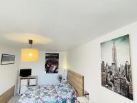 a bedroom with a bed and a poster on the wall at Gite du Moulin in Saint-Laurent-dʼAndenay