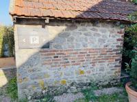 a sign on the side of a brick wall at Gite du Moulin in Saint-Laurent-dʼAndenay