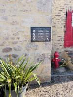 a sign on the side of a building with a red fire hydrant at Gite du Moulin in Saint-Laurent-dʼAndenay