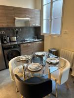 a kitchen with a table and chairs and a kitchen with a stove at Spacious LOFT near JARDIN du LUXEMBOURG in Paris